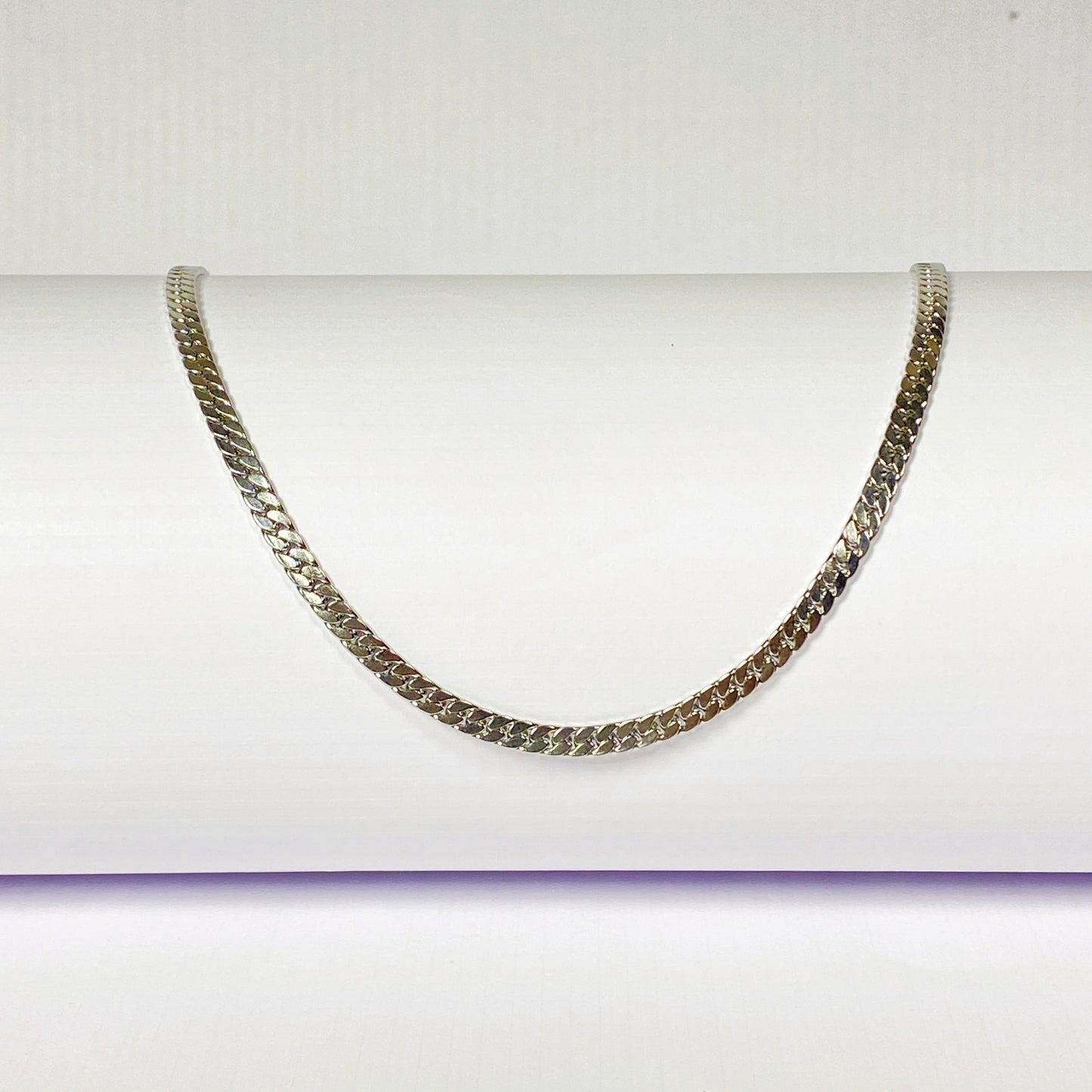Silver chain necklace on a white background