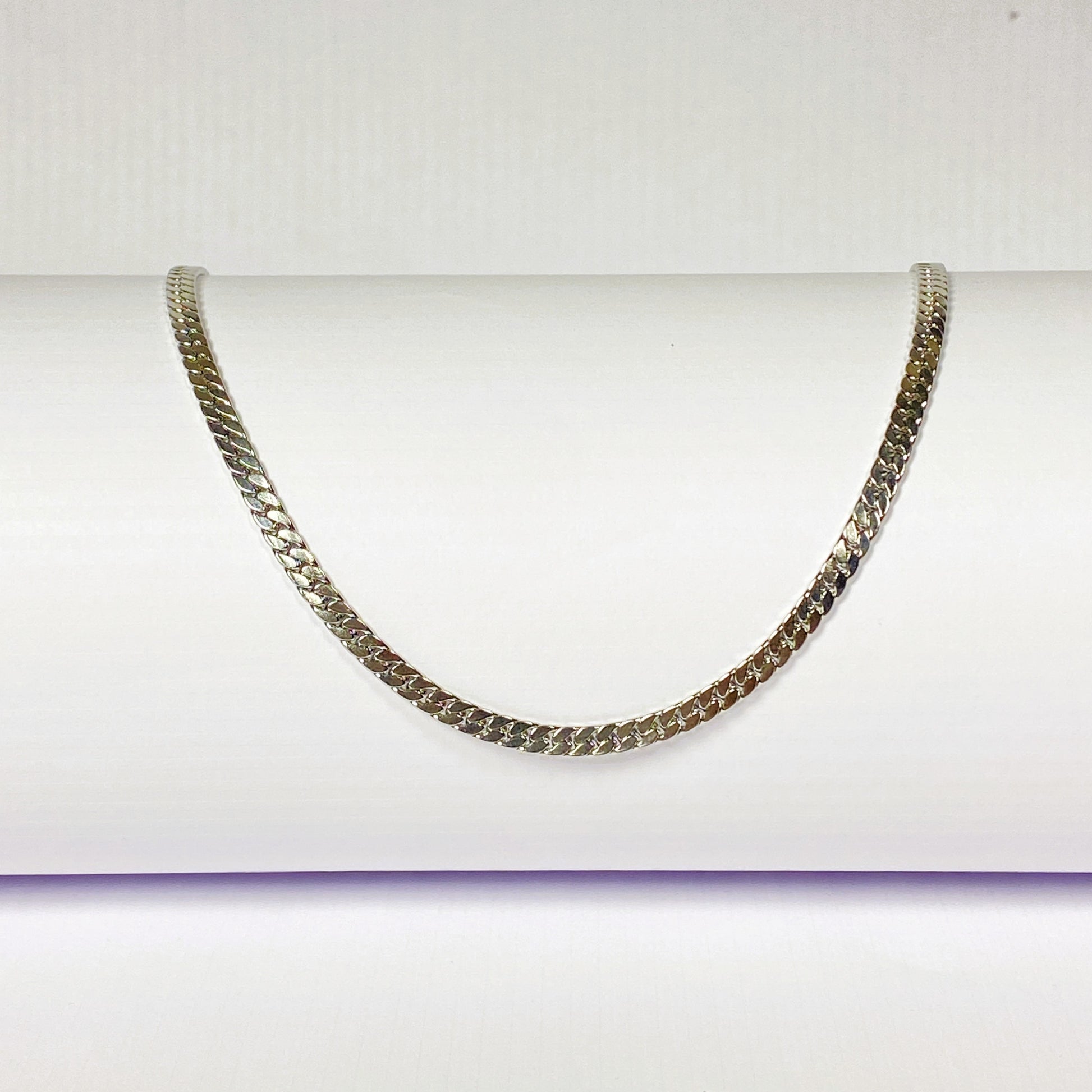 Silver chain necklace on a white background