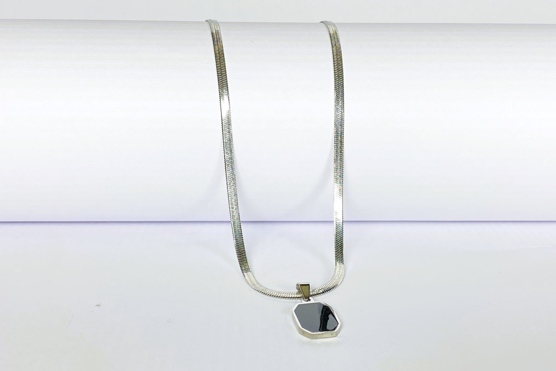 Silver necklace with a pendant on a white background