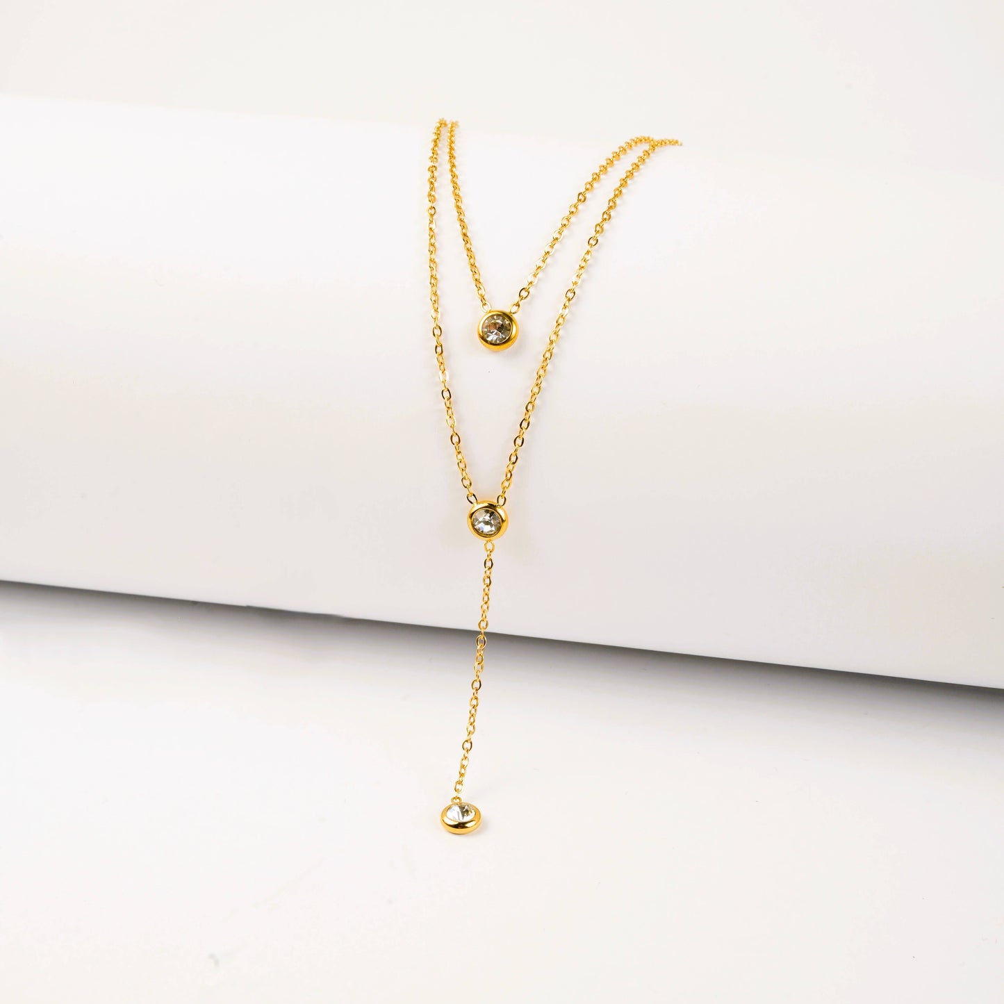 Gold necklace on a white surface