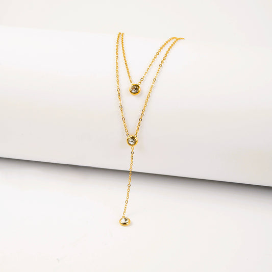 Gold necklace on a white surface